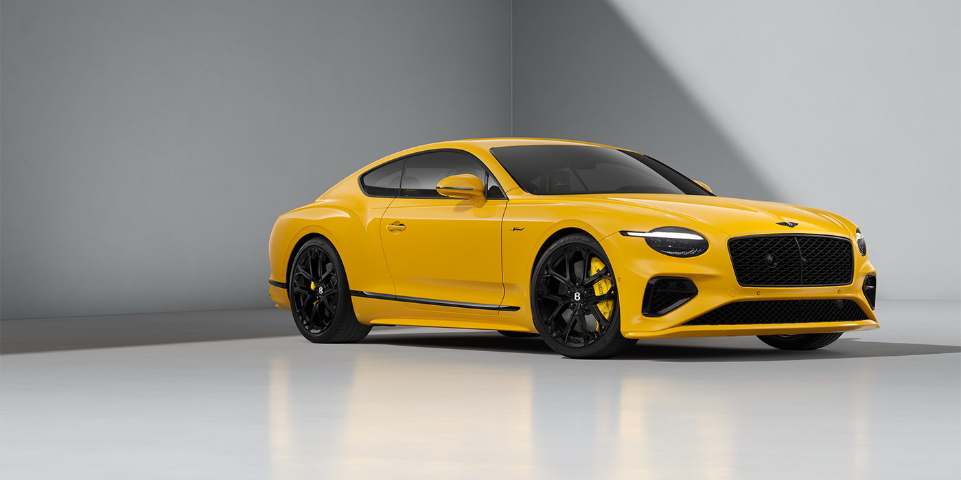Bentley Hannover Bentley Continental GT Speed coupe in Monaco Yellow paint and 22" Ten spoke sport wheels - front 3/4