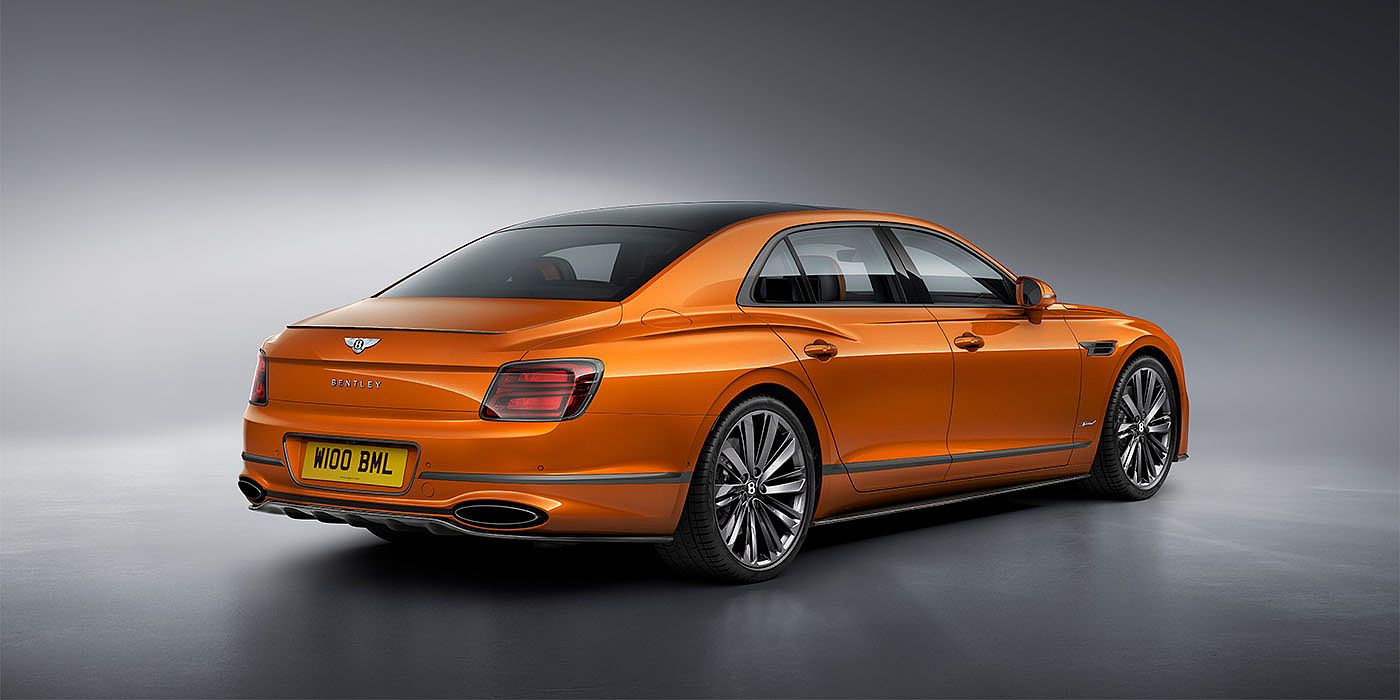 Bentley Hannover Bentley Flying Spur Speed in Orange Flame colour rear view, featuring Bentley insignia and enhanced exhaust muffler.