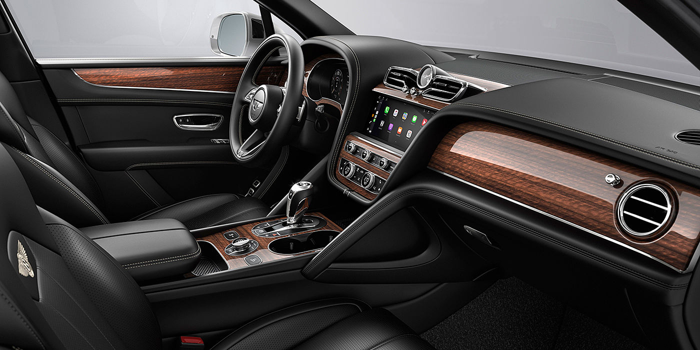 Bentley Hannover Bentley Bentayga interior with a Crown Cut Walnut veneer, view from the passenger seat over looking the driver's seat.