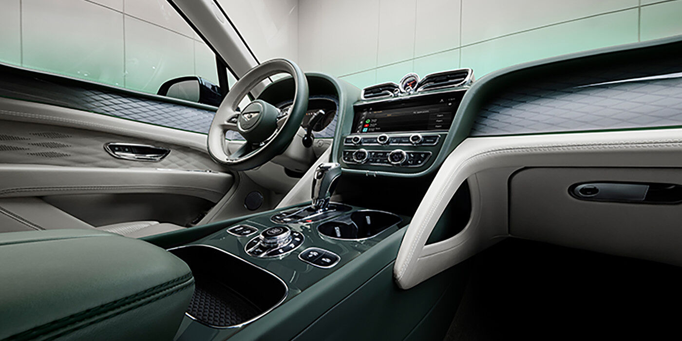 Bentley Hannover Bentley Bentayga Atelier Edition SUV front interior in Portland and Cumbrian Green hides with Dark Tint Diamond Brushed Aluminium veneer