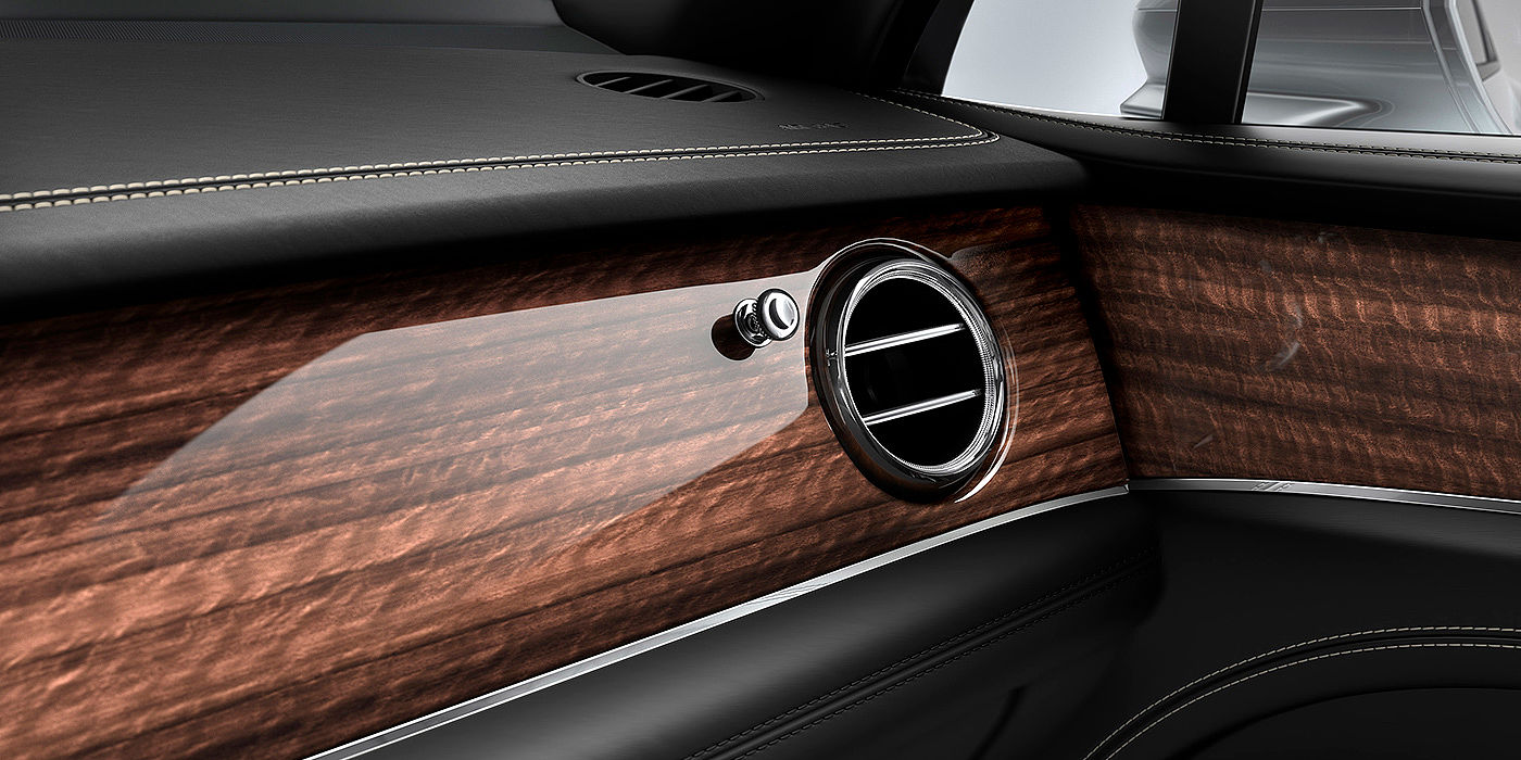 Bentley Hannover Bentley Bentayga front interior Crown Cut Walnut veneer and chrome air vent.