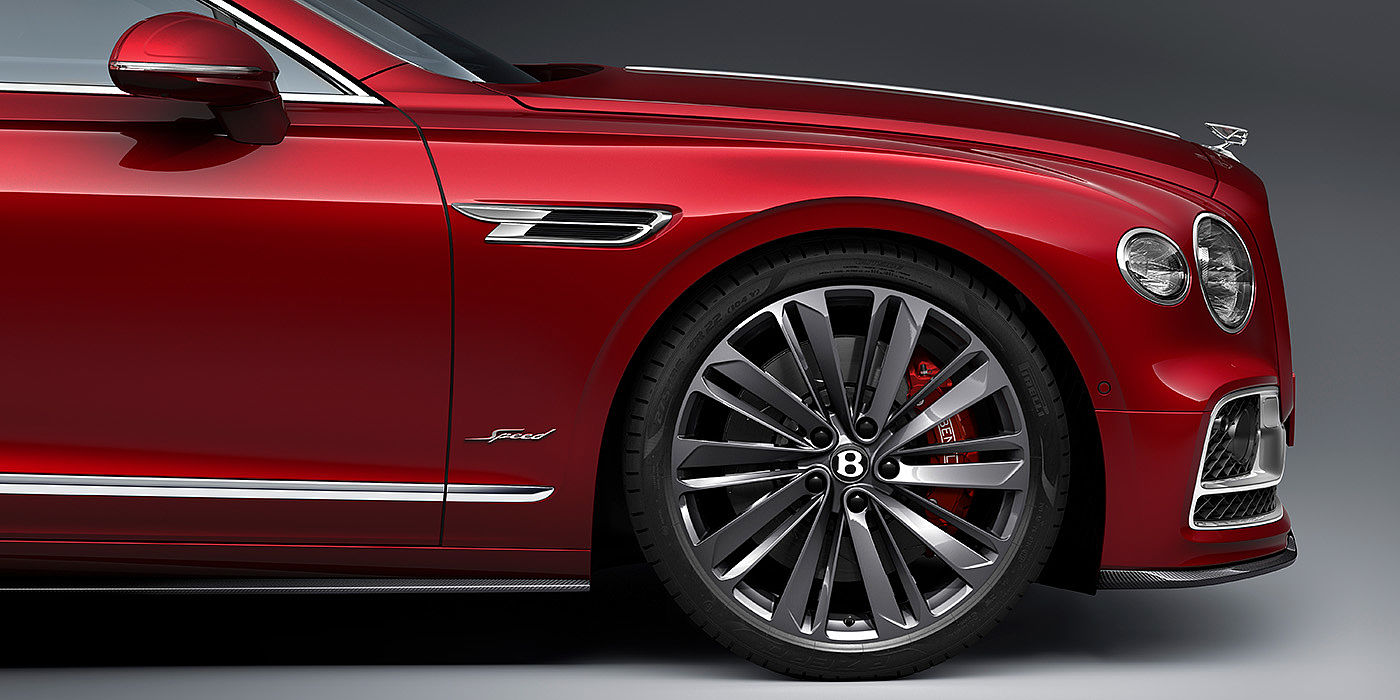 Bentley Hannover Bentley Flying Spur Speed sedan front wheel in close up with Dragon Red II paint