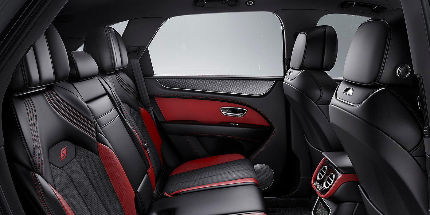 Bentley Hannover Bentey Bentayga S interior view for rear passengers with Beluga black and Hotspur red coloured hide.
