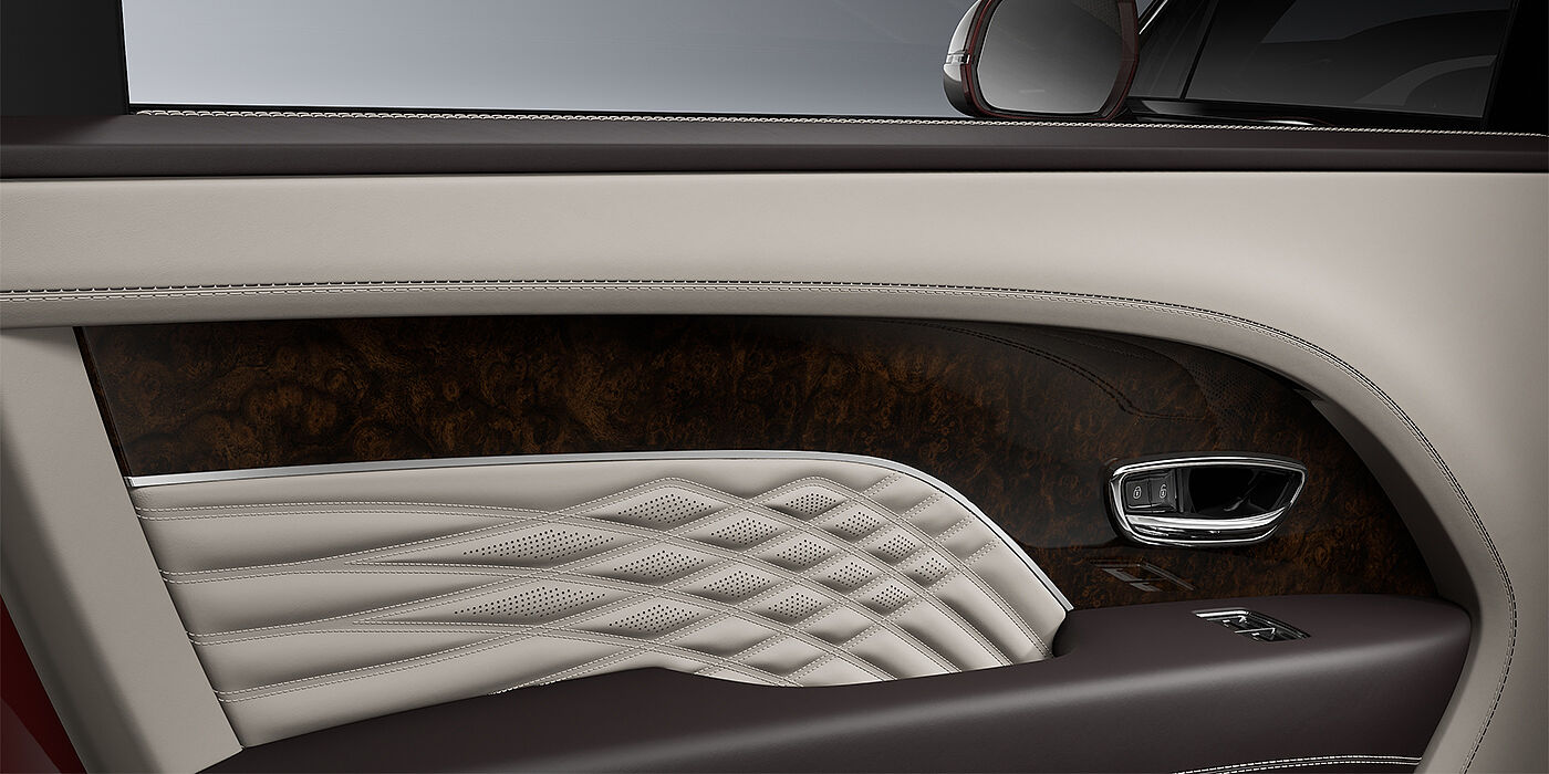 Bentley Hannover Bentley Bentayga EWB Azure SUV door interior detail in Linen and Burnt Oak hides with Dark Stained Burr Walnut veneer