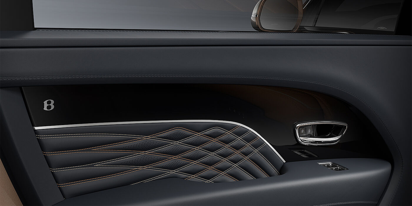Bentley Hannover Bentley Bentayga EWB Mulliner SUV door interior detail in Brunel hide and Grand Black veneer with Mulliner contrast stitching