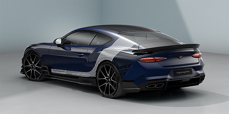 Bentley Hannover Bentley Supersports rear three quarter in "Skies" Design theme with Electric Blue paint finish and Arctica white and Oxford blue paint stripes across the rear haunch.