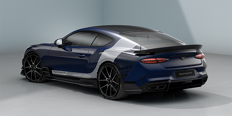 Bentley Hannover Bentley Supersports rear three quarter in "Skies" Design theme with Electric Blue paint finish and Arctica white and Oxford blue paint stripes across the rear haunch.