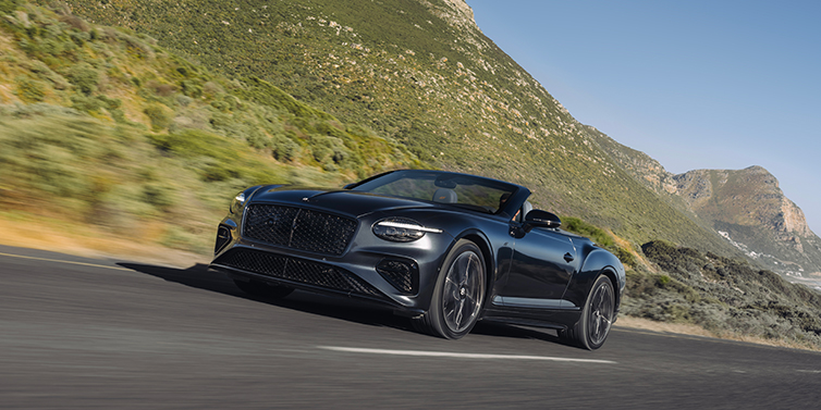 Bentley Hannover Bentley Continental GTC S convertible in Thunder paint front 3/4 driving on mountain road