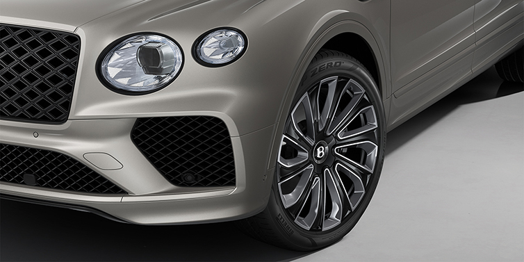 Bentley Hannover Bentayga EWB Artenara Edition SUV in Pale Brodgar paint with 22" Mulliner Gloss black wheel close up