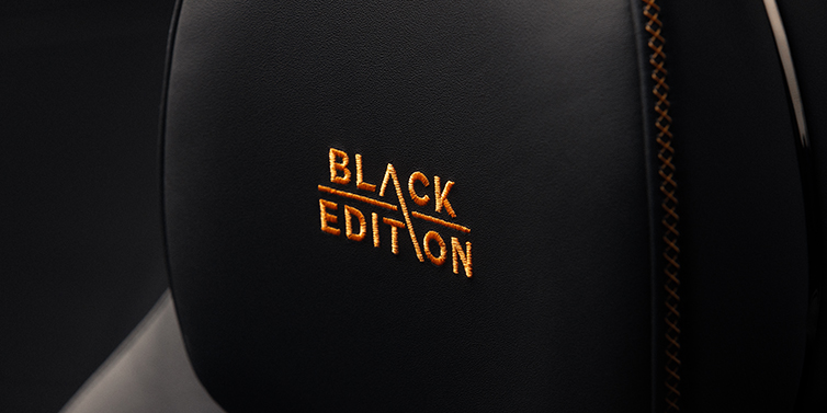 Bentley Hannover Bentley Continental GT coupe seat headrest Black Edition stitched emblem in Mandarin colour against Beluga black hide